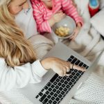 Mother and daughter watching shows on laptop